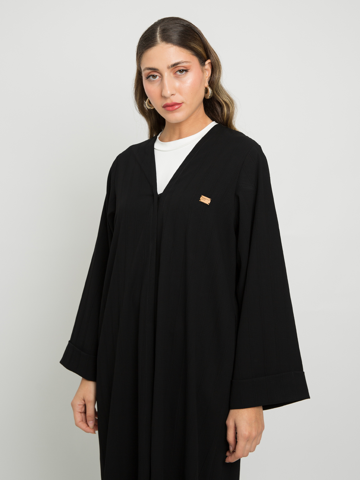 Black v-neck abaya closed with buttons and rolled cuffs in striped fabric online by kaafmeem